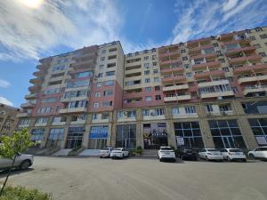 a large building with cars parked in front of it at Ganja Comfort Home in Ganja +7 photos