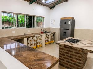 a kitchen with a refrigerator and a counter top at Finca fercho rozo in Rozo