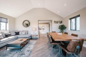 a living room with a table and a couch at The Penthouse @ Carus Green in Kendal