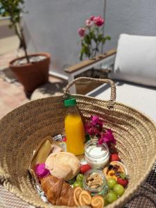 a basket filled with food and a bottle of orange juice at Mar-Ria 5 in Fuzeta