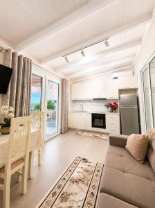 a kitchen and living room with a couch and a table at Deon in Vlorë