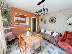 a living room with a table and a couch at 100m des dunes de Stella-plage in Cucq