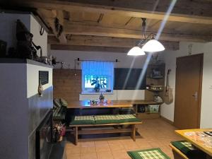 a kitchen with a table and a bench in a room at penzion ŽEROTÍN in Staré Město