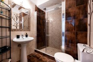 a bathroom with a shower and a toilet and a sink at Fourka Garden Villas in Fourka +16 photos