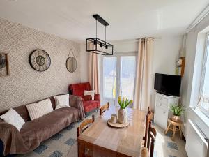 a living room with a couch and a table at 100m des dunes de Stella-plage in Cucq