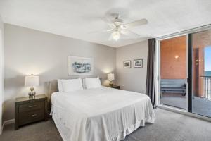 a bedroom with a bed and a ceiling fan at Buena Vista Condominiums in Gulf Shores