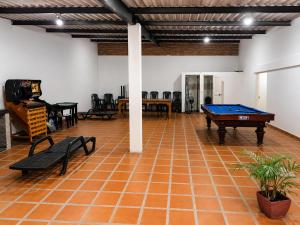 a room with a ping pong table and chairs at Finca fercho rozo in Rozo