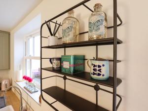 a shelf with glass jars on it in a kitchen at 4 Eve Street in Louth