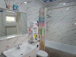 a bathroom with a sink and a toilet and a tub at Dosoi Guest House Experience Song-Kul with Horseback Tours in Kyzylemgek +34 photos
