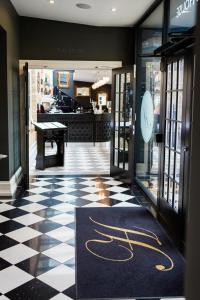 a store entrance with a black and white checkered floor at Poets House in Ely
