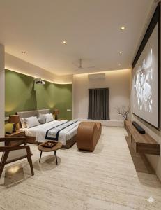 a bedroom with a large bed and a large screen at Hotel VD Rooms Althan in Surat