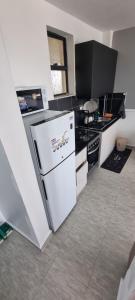 a kitchen with a white refrigerator and a stove at Dolphin Homestays in Nairobi