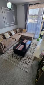a living room with a couch and a coffee table at Dolphin Homestays in Nairobi