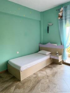 a bedroom with a bed and a blue wall at Marsia House in Vathí +5 photos