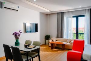 a living room with a couch and a table at Lumia Hotel Vinh Yen in Vĩnh Phúc