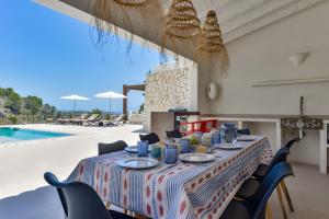 a long table with blue dishes on it next to a pool at Caray - Managed by Almarina Villas in Benissa