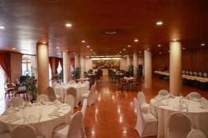 a banquet hall with white tables and chairs at Beach Luxury Hotel in Karachi