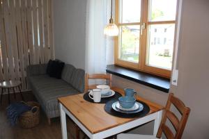 a small living room with a table and a couch at Fewo Obermoos in Teisendorf +15 photos