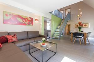 a living room with a couch and a staircase at Kauperhof in Burg