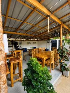a dining room with wooden tables and chairs at Dreamy Hostel Arugambay in Arugam Bay
