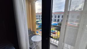 a room with a view of a pool from a window at ADRi in Phú Quốc