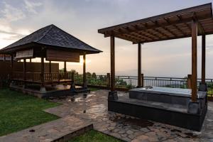 a gazebo with a hot tub in a yard at Shankara Munduk Bali in Munduk