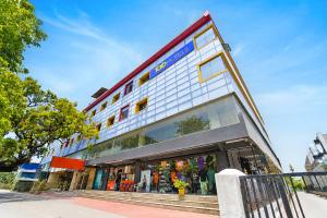 a store front of a building on a street at FabHotel Sca - Gandhipuram in Coimbatore