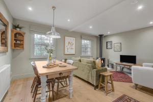 a living room with a table and a couch at Claytons Hideaway in Adlestrop