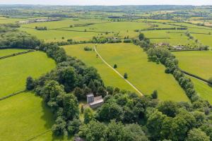 an aerial view of a green field with trees at Claytons Hideaway in Adlestrop