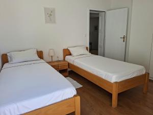 a room with two beds and a mirror at Sea View Apartments in Selca +28 photos