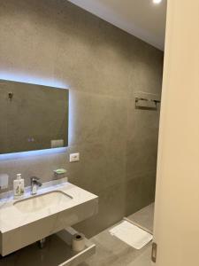 a bathroom with a sink and a mirror at Hotel Noel in Vlorë +60 photos