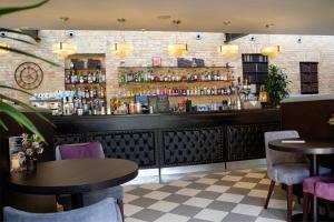 a restaurant with two tables and a bar at Poets House in Ely