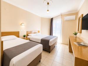 a hotel room with two beds and a television at Yaman Life Hotel in Alanya +23 photos
