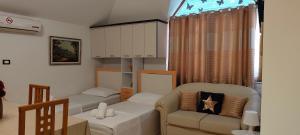 a living room with a couch and a table at Lille France Apartments in Shkodër