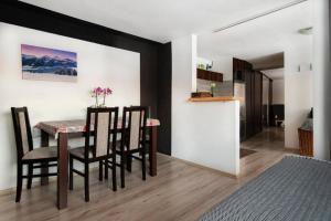 a dining room with a table and some chairs at Apartman Borievka in Poprad
