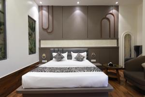 a bedroom with a large bed and a couch at Hotel Marina in Meerut