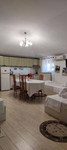 a kitchen and dining room with a table and chairs at Lille France Apartments in Shkodër