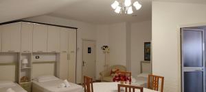 a dining room with a table and chairs and a chandelier at Lille France Apartments in Shkodër +40 photos