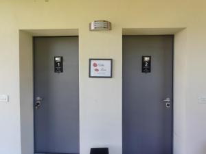 a row of three doors in a room at Villa Luisa Appartamenti Vacanze in Caiolo