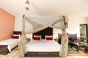 a bedroom with a bed with a canopy at Riad Saida Atlas in Marrakesh +127 photos