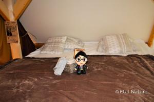 a cartoon character sitting on top of a bed at Gîte du sorcier - Etat Nature in Magnières +18 photos