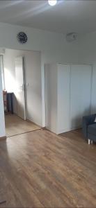 an empty living room with a couch and a table at Wzgórze za miedzą - Niezależne Studio z osobnym wejściem in Sicienko