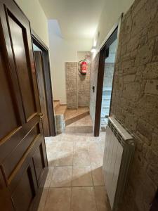 a hallway with a door and a stone wall at Il Rifugio nel Matese in San Massimo