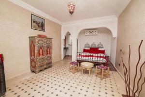 a room with a bedroom with a bed and a dresser at Riad Saida Atlas in Marrakesh