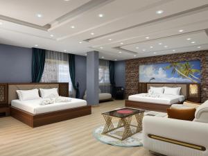a living room with two beds and a couch at JubingeHotel 聚滨阁华人酒店 in Cairo