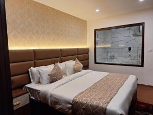 a bedroom with a large bed with a large window at Rufina Pinasa Residency in Gangtok +55 photos