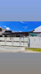 a building with a fence in front of it at Pirate's Cove in Malacca