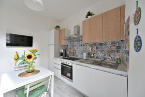 a kitchen with white cabinets and a white counter top at Little Cozy House in Loro Ciuffenna
