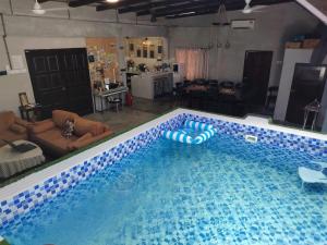 a large swimming pool in a living room at Pirate's Cove in Malacca