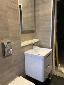 a bathroom with a white sink and a mirror at Seabreeze in North Berwick +11 photos